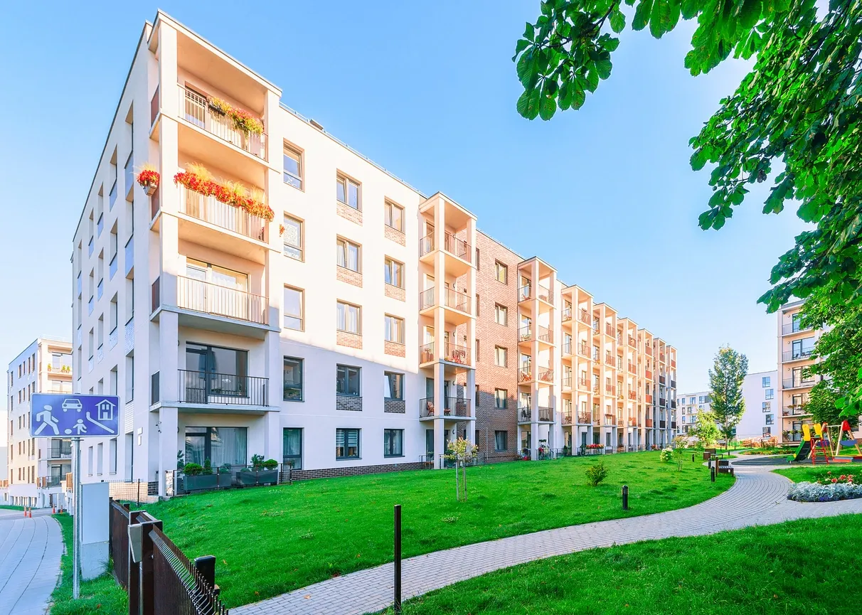 A large white building with many balconies on it.