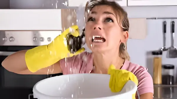 A woman in yellow gloves is washing dishes.